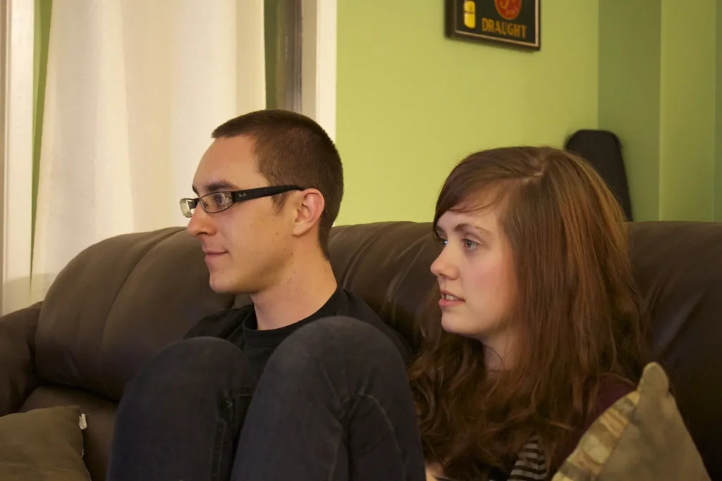 Two people on a sofa playing a video game together