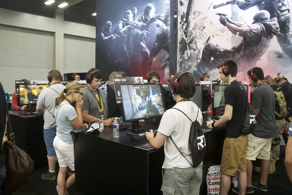 Rows of players wearing headsets at gaming stations