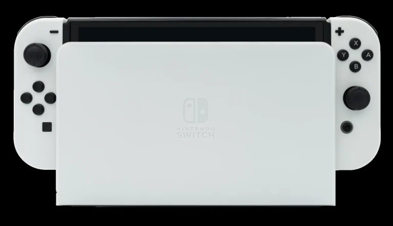 Nintendo Switch OLED model in its dock with Joy-Con controllers