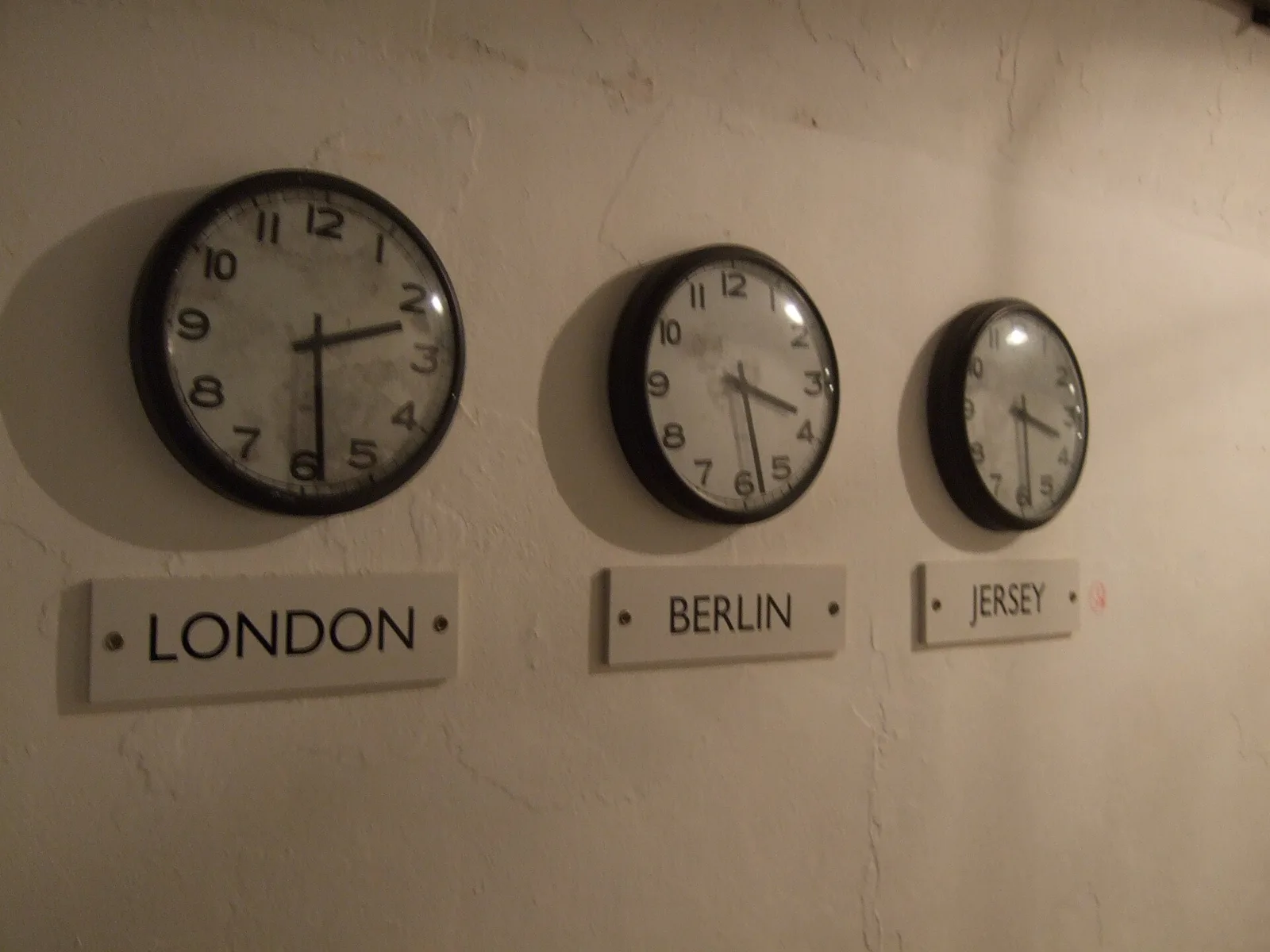 Wall clocks showing different time zones